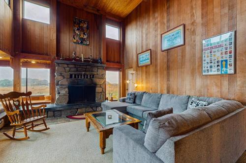 a living room with a couch and a fireplace at Norman House in Sea Ranch