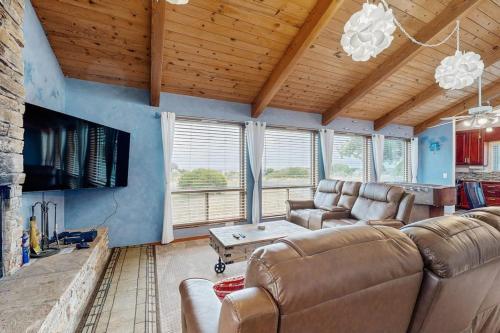 a living room with a couch and a tv at Ocean Star in Sea Ranch
