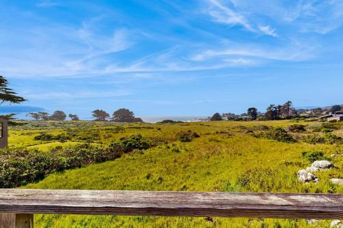 a view of a field with a wooden fence at Thayer House in Sea Ranch