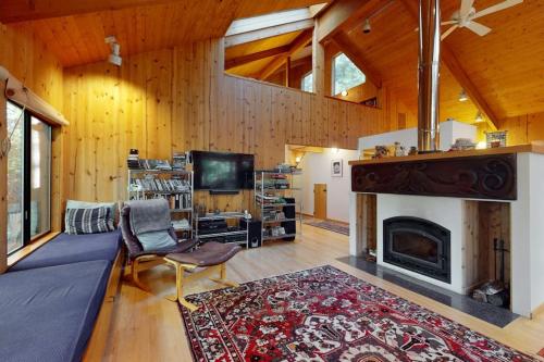 a living room with a fireplace and a tv at Longwell House in Sea Ranch