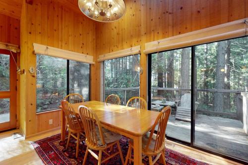 a dining room with a wooden table and chairs at Longwell House in Sea Ranch