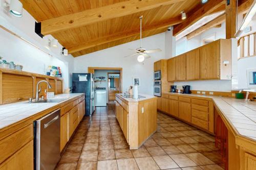 a large kitchen with wooden cabinets and a ceiling at Double R in Gualala
