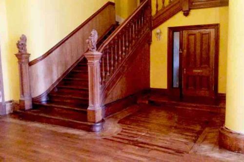 an empty room with a staircase and a door at The Manor House, Killearn in Killearn