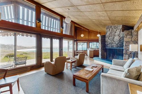a large living room with a large stone fireplace at Curtis-Moulton Retreat in Sea Ranch