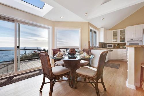 a kitchen and dining room with a table and chairs at The Cliff House in Gualala