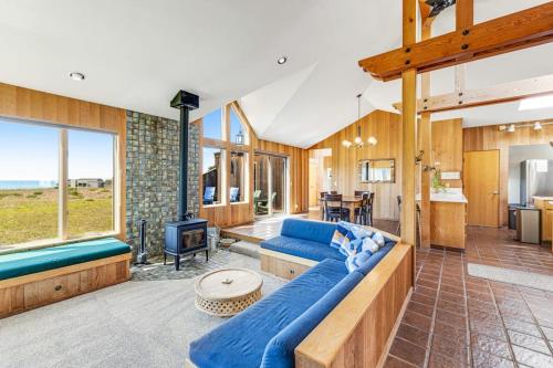a living room with a blue couch and a table at Toto House in Gualala
