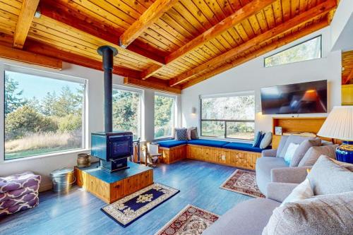a living room with a couch and a tv at The Bobcat House in Sea Ranch