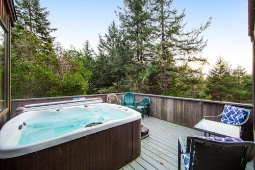 a hot tub on the deck of a house at The Bobcat House in Sea Ranch