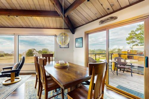 a dining room with a wooden table and chairs at Seas the Day in Sea Ranch