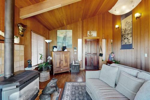 a living room with a couch and a stove at Nature's Paradise in Gualala
