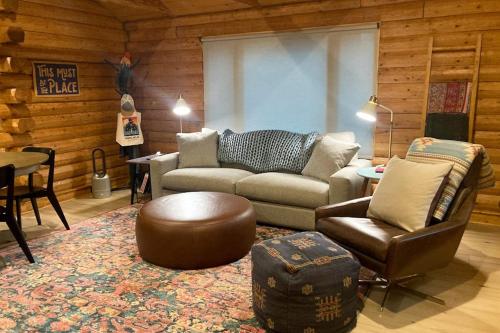 a living room with a couch and a chair at Cabin Fever in Gualala