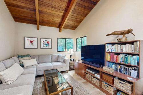 a living room with a couch and a tv at Sea Trees in Sea Ranch