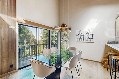 a dining room with a glass table and chairs at Sea Trees in Sea Ranch