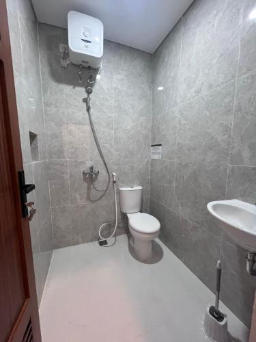 a bathroom with a toilet and a sink at The Haven Suites Batam in Tanjunguma