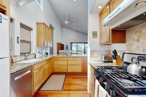 a kitchen with wooden cabinets and a stove top oven at Footloose in Sea Ranch