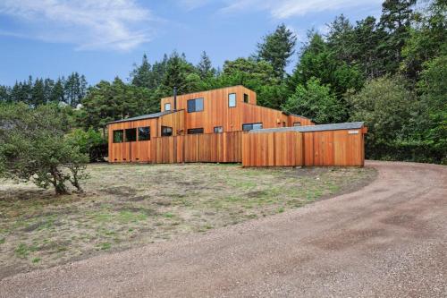 a wooden house with a fence in a field at Rainbow's End in Valley Crossing