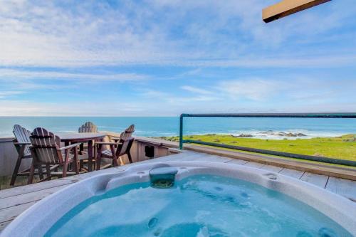 a hot tub on a balcony with a view of the ocean at Compass Rose in Sea Ranch