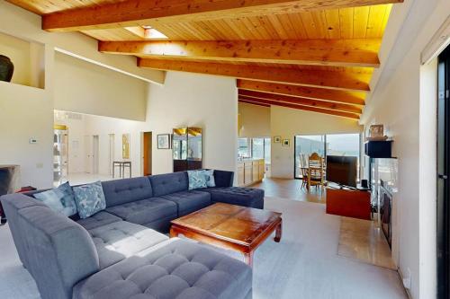 a living room with a blue couch and a table at Whale Tales in Gualala