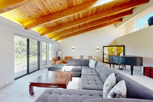 a living room with a couch and a piano at Whale Tales in Gualala
