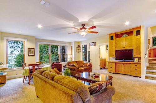 a living room with a couch and a tv at Spyglass View in Sea Ranch
