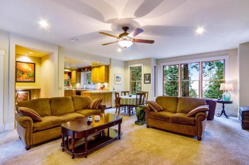a living room with two couches and a ceiling fan at Spyglass View in Sea Ranch