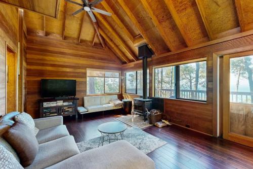 a living room with a couch and a tv at Redwood Grove in Sea Ranch