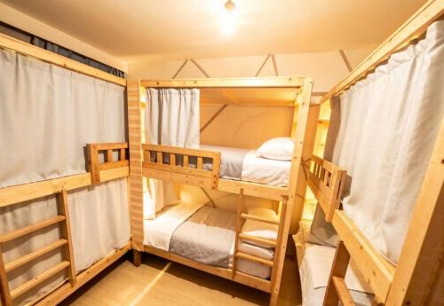 a bunk bed room with two bunk beds at YangShuo Backpacker Hostel West Street Branch in Yangshuo