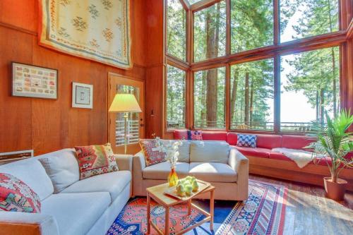a living room with a couch and a table at The Redwood House in Fish Rock