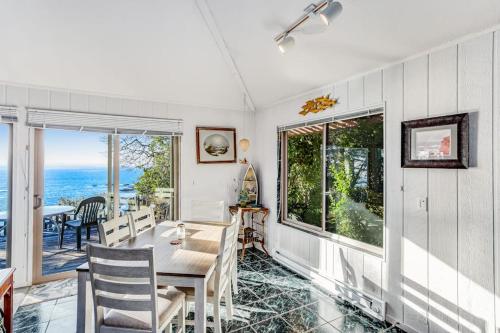 a dining room with a table and a view of the ocean at Cove House in Gualala