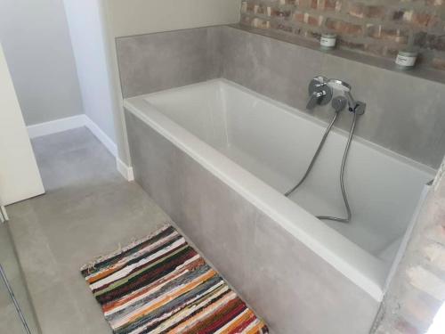 a white bath tub with a faucet in a bathroom at Crystal Self Catering 3 bedroom Villa in Swakopmund