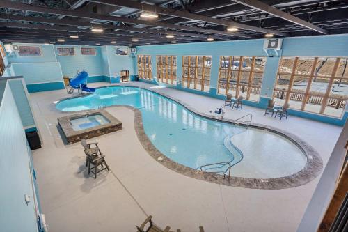 a large swimming pool in a large building at Peaceful Timbers Getaway in Hollister