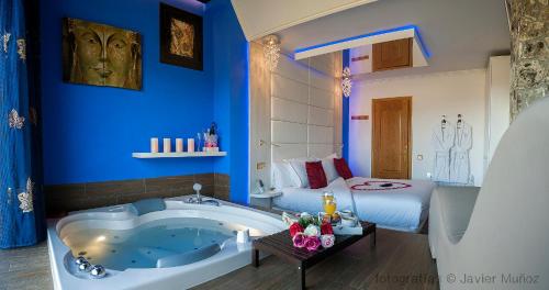 a bathroom with a tub and a bedroom with a bed at Suite Rural Carenas in Carenas
