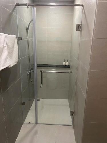 a shower with a glass door in a bathroom at Homestay THAIPHONG DRAGON CASTLE Bãi Cháy in Ha Long