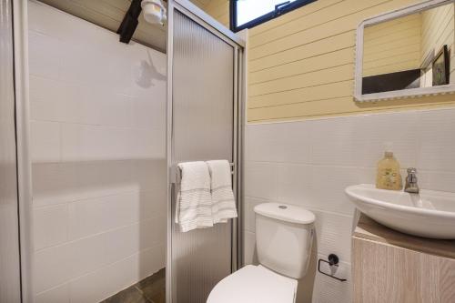 a bathroom with a toilet and a sink at Tiny House La Silleta in Medellín