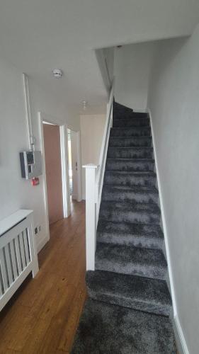 a hallway with a staircase in a house at Brooklyn House in Elmers End