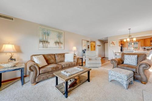 a living room with two couches and a table at Chetola Cardinal 201 in Blowing Rock