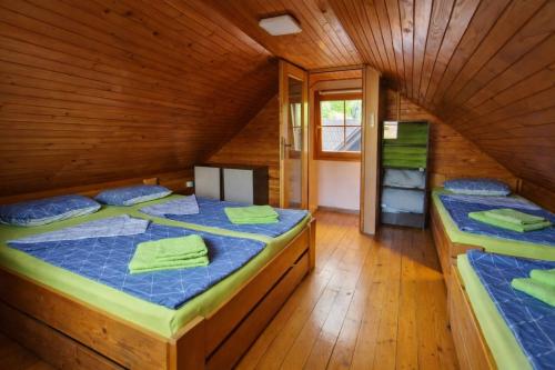 a bedroom with two beds in a wooden house at Hiška Arijela, Terme Čatež, oaza sprostitve, Slovenija in Brežice