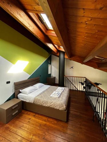 a bedroom with a bed in a room with wooden ceilings at Appartamento Il Loftino in Forlì