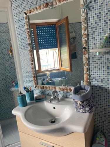 a bathroom with a sink and a mirror at Casa Dina Blu alle Morge in Torino di Sangro