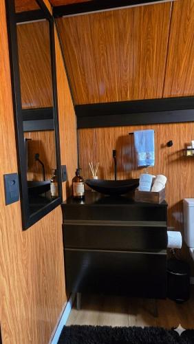 a bathroom with a sink and a mirror at Chalés da colina em Victor Graeff in Cochinho