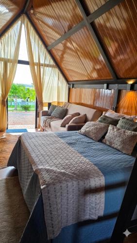 a bedroom with two beds in a large room at Chalés da colina em Victor Graeff in Cochinho