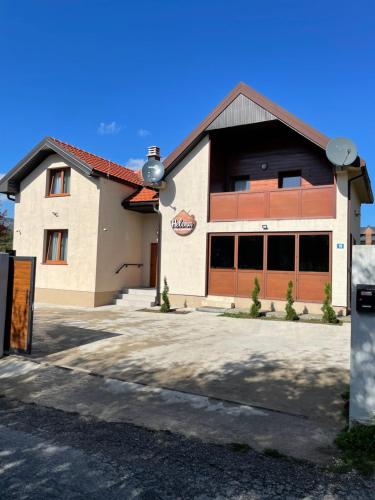 a building with a garage with a sign on it at Vila&Apartments Helena in Kolašin