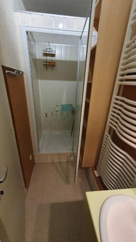 a bathroom with a glass shower and a sink at appartement 4 places centre-ville in Cauterets