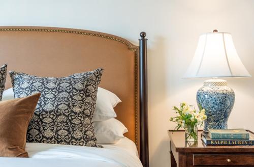 a bedroom with a bed with a lamp on a table at Hotel Burg in Leesburg