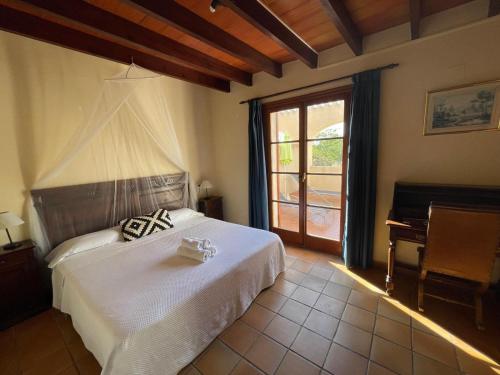 a bedroom with a white bed and a window at Hotel Torre San Juan in San Juan de Alicante