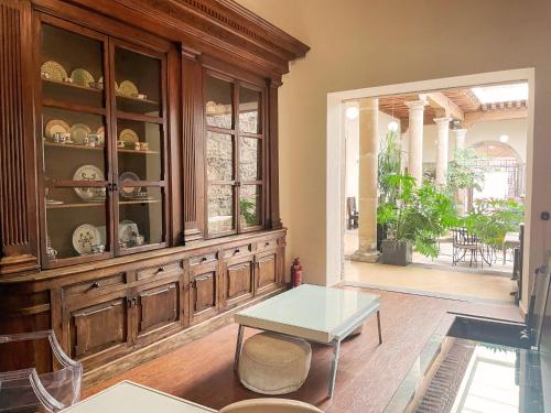 a dining room with a wooden hutch and a table at Hotel Expres By Hosting House in Morelia