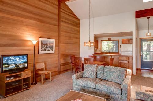 a living room with a couch and a dining room at 108 Quelah Condo in Sunriver