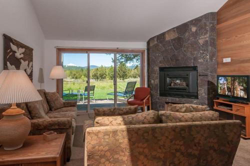 a living room with a couch and a fireplace at 108 Quelah Condo in Sunriver