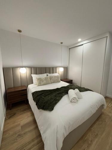 a bedroom with a large bed with two towels on it at Coração d`Alice in Monção