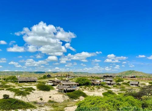 a village in the desert under a blue sky with clouds at Villa Vichayo Bungalows in San Martín